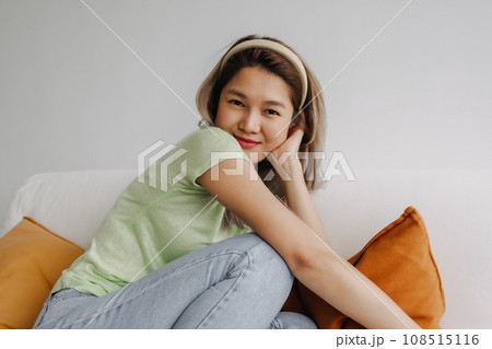 Happy and chill vibes asian woman alone in living room. Concept of love myself Happy and chill vibes asian woman alone in living room. Concept of love myself 108515116