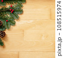 Christmas background of green fir branches with red berries and brown cones. 108515974