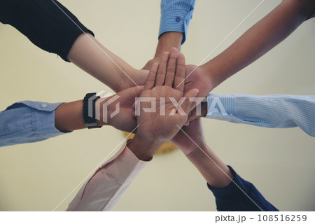 Partners hands together teamwork group of business people meeting in firm company office. Diversity Hands join empower partnership teams connection community. Success Mergers acquisitions partnership 108516259
