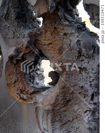 Wall, hole and damage of a concrete structure during war on a battlefield for military conflict. Construction, building and target shooting with exterior destruction of a surface in a warzone 108518471