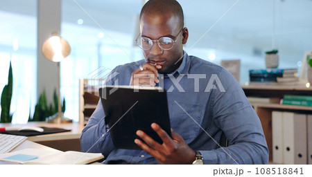 Businessman, hold and tablet while thinking in office, late and work on app, telemarketing or analytics. Black person, face and reading of reports of data, online or documents for customer support Businessman, hold and tablet while thinking in office, late and work on app, telemarketing or analytics. Black person, face and reading of reports of data, online or documents for customer support 108518841