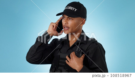 Security guard, phone call and man with communication in a studio with police and law enforcement. Blue background, surveillance and officer with mobile discussion and talking for safety and danger 108518967