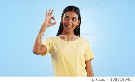 Woman, OK hand gesture and agreement for success or support with smile and mockup space on blue background. Like, yes and emoji with feedback, vote or opinion in studio with thank you or praise 108519040