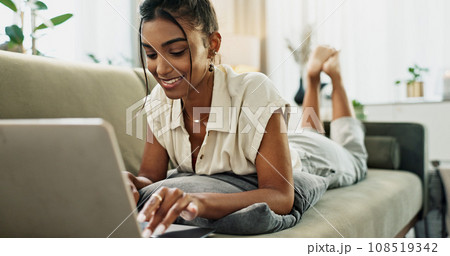 Woman, remote work and relax on sofa with laptop to update blog post, social media or digital subscription. Happy indian freelancer, lounge and computer for online shopping, elearning or typing email Woman, remote work and relax on sofa with laptop to update blog post, social media or digital subscription. Happy indian freelancer, lounge and computer for online shopping, elearning or typing email 108519342