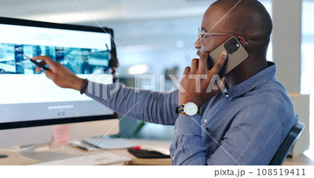 Businessman, phone call and pointing at computer in office while talk, consult or listen. Black person, analyst or developer for customer service with communication, feedback or support on website Businessman, phone call and pointing at computer in office while talk, consult or listen. Black person, analyst or developer for customer service with communication, feedback or support on website 108519411