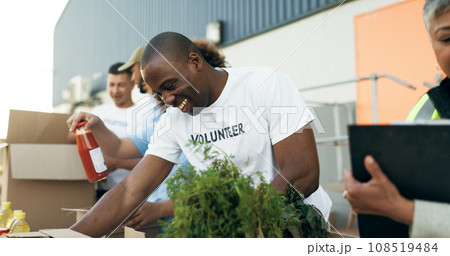 Volunteer, men and women with food boxes on table for charity event with care, kindness and smile. Community donation, help and team at ngo with grocery package distribution at non profit project. 108519484