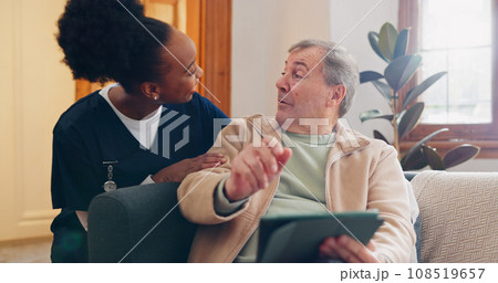 Tablet, nurse and senior man on sofa browsing on internet for medical consultation research. Bonding, healthcare and black woman caregiver talking to elderly patient networking on technology at home. 108519657