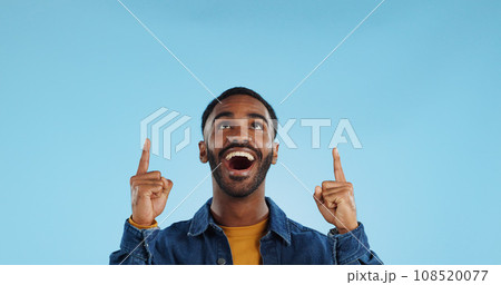 Happy man, pointing and news announcement with portrait in studio, surprise emoji and advertising. Mockup, mexican person and smiling in casual fashion for offer and notification by blue background Happy man, pointing and news announcement with portrait in studio, surprise emoji and advertising. Mockup, mexican person and smiling in casual fashion for offer and notification by blue background 108520077