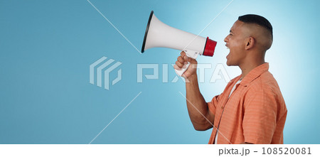 Man, megaphone and voice for protest, angry speech in politics, justice and vote for change on blue background. Profile of young leader with noise, call to action or shout on mockup or studio banner 108520081