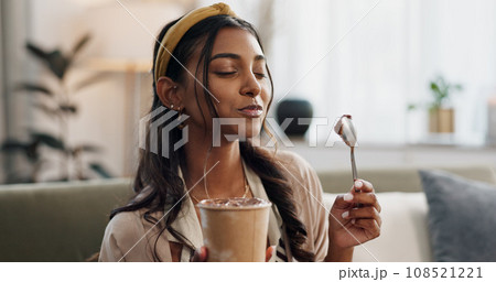Woman, eating ice cream and living room on couch, thinking or idea for dessert, sweets or relax in home. Girl, gelato or frozen yogurt for snack, lounge sofa and house with memory, choice or decision Woman, eating ice cream and living room on couch, thinking or idea for dessert, sweets or relax in home. Girl, gelato or frozen yogurt for snack, lounge sofa and house with memory, choice or decision 108521221