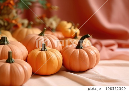 Small decorative pumpkins lie on a peach background Small decorative pumpkins lie on a peach background 108522399