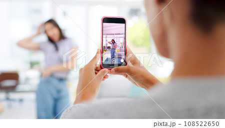Phone, woman and influencer recording video for social media, vlog or online post dancing at home. Hands, cellphone and female content creator live streaming and moving to music in living room. Phone, woman and influencer recording video for social media, vlog or online post dancing at home. Hands, cellphone and female content creator live streaming and moving to music in living room. 108522650