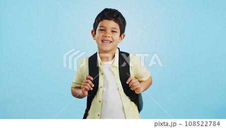 School, happy or face of child in studio on blue background ready for class, learning and education. Student, smile or portrait of a young boy with bag excited for lesson, academy or kindergarten 108522784