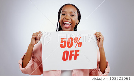Portrait, sale sign or happy black woman by discount deal, 50 percent off offer or launch ad. Excited, smile or person with board for message, marketing or promotion card on grey background in studio Portrait, sale sign or happy black woman by discount deal, 50 percent off offer or launch ad. Excited, smile or person with board for message, marketing or promotion card on grey background in studio 108523061