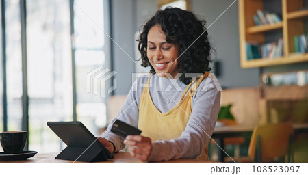 Tablet, credit card and woman in restaurant, online shopping and payment in coffee store. Tech, plastic money and happy person in cafe in ecommerce, digital fintech or typing on financial banking app 108523097
