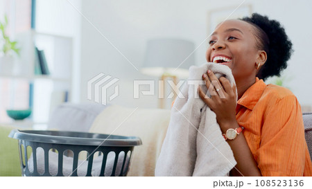 Clean, smell and happy woman with laundry in home or basket with clothes, linen or maid spring cleaning in apartment. Black person, washing or clothing with detergent or cleaner scent on fresh fabric 108523136