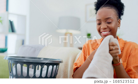 Clean, laundry and black woman with basket in home for clothes, linen or maid with spring cleaning in apartment. Washing, clothing and happy cleaner in house to wash bedding, towel or dirty fabric 108523512