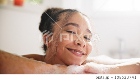 Happy, peace and face of a woman in a bath at her home for calm, relaxing and self care routine. Smile, headshot and portrait of young female person from Mexico with mindfulness in a tub in bathroom. 108523741