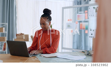 Fashion, designer and black woman with laptop for ecommerce, clothes brand and delivery in workshop. Retail, boutique and person on computer for creative startup, small business and supply chain 108523902