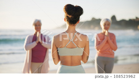 Beach yoga class, people and back of coach teaching exercise, outdoor wellness and relax workout. Trainer, community instructor and yogi group learning pose, training and teacher coaching pilates Beach yoga class, people and back of coach teaching exercise, outdoor wellness and relax workout. Trainer, community instructor and yogi group learning pose, training and teacher coaching pilates 108523962