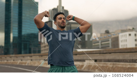 Fitness, winner and a sports man in the city for marathon running to improve cardio performance. Exercise, success and workout goals with a young runner or athlete on a bridge in an urban town Fitness, winner and a sports man in the city for marathon running to improve cardio performance. Exercise, success and workout goals with a young runner or athlete on a bridge in an urban town 108524004