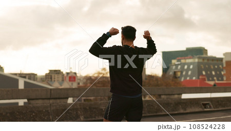Man, runner or victory in city for exercise time, fitness progress or training goal. Male person, athlete or cheers or workout performance on cloudy morning in street, challenge or health celebration 108524228