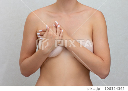 Cropped woman hands monitoring nodules, swellings or cysts on breast by fingers Cropped woman hands monitoring nodules, swellings or cysts on breast by fingers 108524363