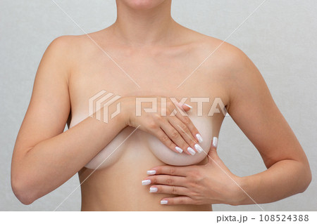 Cropped woman hands monitoring nodules, swellings or cysts on breast by fingers Cropped woman hands monitoring nodules, swellings or cysts on breast by fingers 108524388