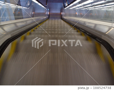 Top view, stairs and escalator in modern building for travel, moving and transport in airport. Metal, steel and closeup of electrical stairway in shopping mall, office or subway for urban commute 108524738