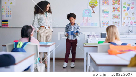 School, child and reading a book in class for learning, development and communication. A african boy kid or student and teacher woman for language, support and assessment in elementary classroom 108525007