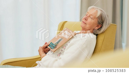 Relax, book and senior woman sleeping in the living room of her modern house on a weekend. Calm, peace and elderly female person in retirement taking a nap after reading a story or novel at home. 108525383