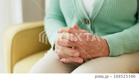 Hands, anxiety and senior woman on a sofa with stress, fear or grief, dementia or scared in her home. Stress, worry and nervous elderly female in a living room with Alzheimer, arthritis or depression 108525390