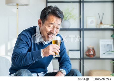 リビングでビールを飲むミドルの男性 リビングでビールを飲むミドルの男性 108526793