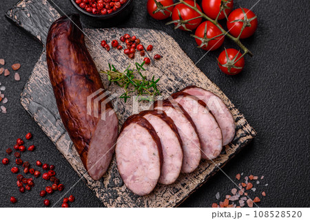 Delicious smoked sausage with salt and spices cut into slices 108528520