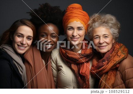 Half-length portrait of four cheerful senior diverse multiethnic women. Female friends smiling at camera while posing together. Diversity, beauty, friendship concept. Isolated over grey background. 108529112
