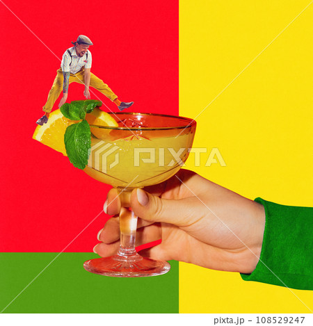 Young man jumping over sweet and sour cocktail with orange juice. Margarita cocktail. Contemporary art collage. Poster 108529247