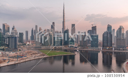 Aerial view to Dubai Business Bay and Downtown with the various skyscrapers and towers night to day timelapse Aerial view to Dubai Business Bay and Downtown with the various skyscrapers and towers night to day timelapse 108530954