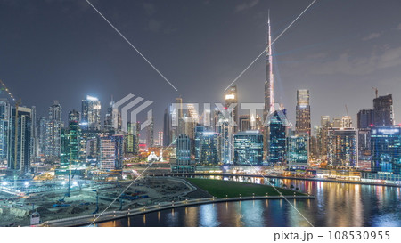 Aerial view to Dubai Business Bay and Downtown with the various skyscrapers and towers night timelapse 108530955