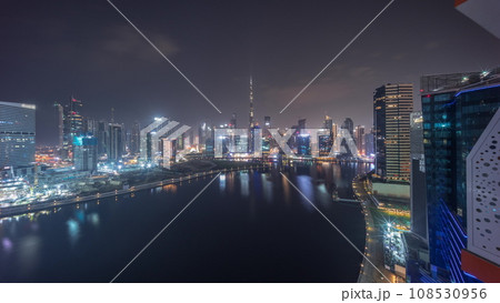 Aerial view to Dubai Business Bay and Downtown with the various skyscrapers and towers all night timelapse Aerial view to Dubai Business Bay and Downtown with the various skyscrapers and towers all night timelapse 108530956