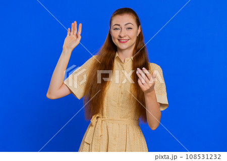 Woman showing inviting gesture with hands, ask to join, beckoning to coming, gesturing hello goodbye 108531232