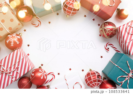 Christmas frame with gift boxes and balls on white Christmas frame with gift boxes and balls on white 108533641