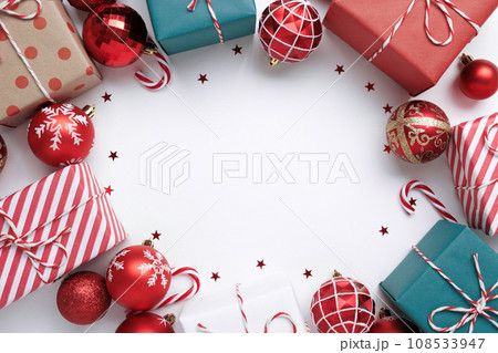Christmas frame with gift boxes and balls on white Christmas frame with gift boxes and balls on white 108533947