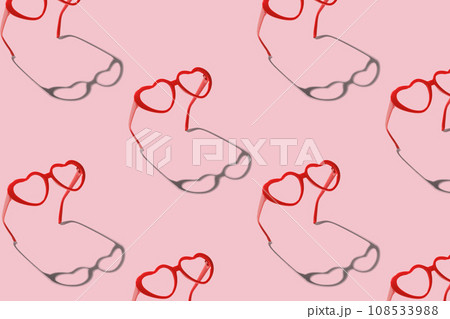 Pattern made with red heart shaped sunglasses on pastel color background Pattern made with red heart shaped sunglasses on pastel color background 108533988