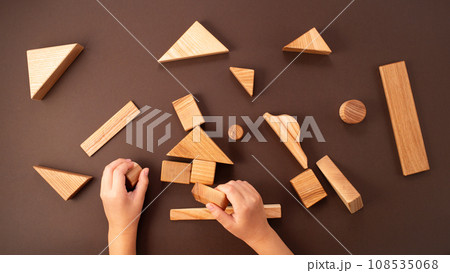 Child hands playing with wooden blocks 108535068
