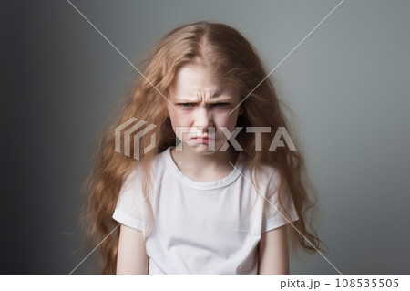 Portrait of little sullen girl frowning eyebrows and looking at camera with dislike. Cute little girl is upset, offended and ready to cry. Beautiful child expresses negative emotion with face and pose Portrait of little sullen girl frowning eyebrows and looking at camera with dislike. Cute little girl is upset, offended and ready to cry. Beautiful child expresses negative emotion with face and pose 108535505