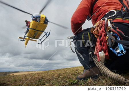 Teamwork of paramedic and firefighters with helicopter emergency medical service 108535749