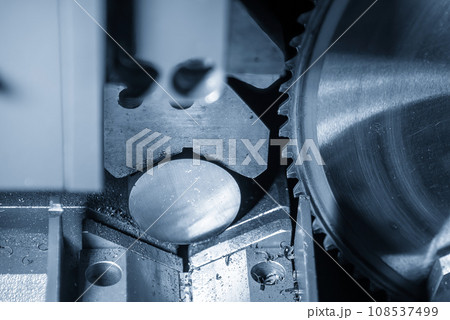 Close up scene the operation of circular blade saw cutting machine cutting the metal shaft parts with coolant method. Close up scene the operation of circular blade saw cutting machine cutting the metal shaft parts with coolant method. 108537499