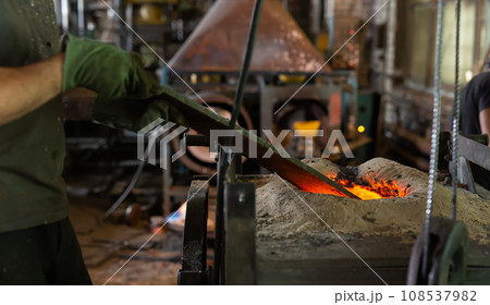 Ferrous metal billet is melted in an induction furnace closeup Ferrous metal billet is melted in an induction furnace closeup 108537982