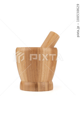 Wooden mortar and pestle for grinding spices isolated on a white background. 108538629