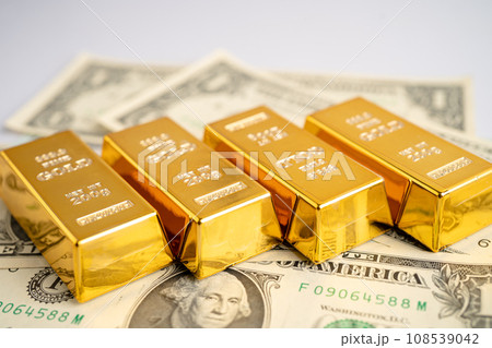 Gold bar on US dollar banknotes money and graph, economy finance exchange trade investment concept. 108539042